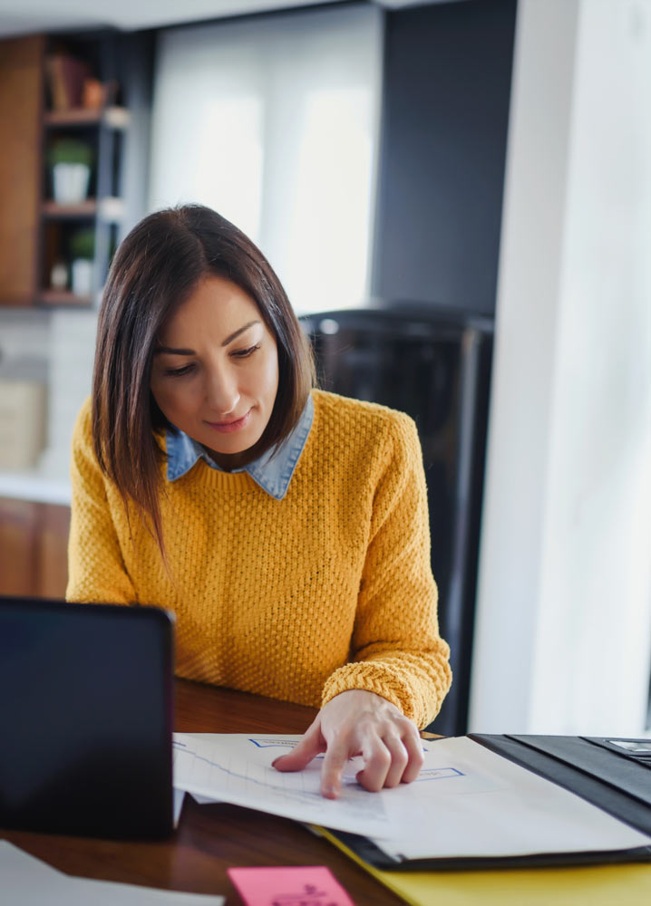 Woman writing in kitchen